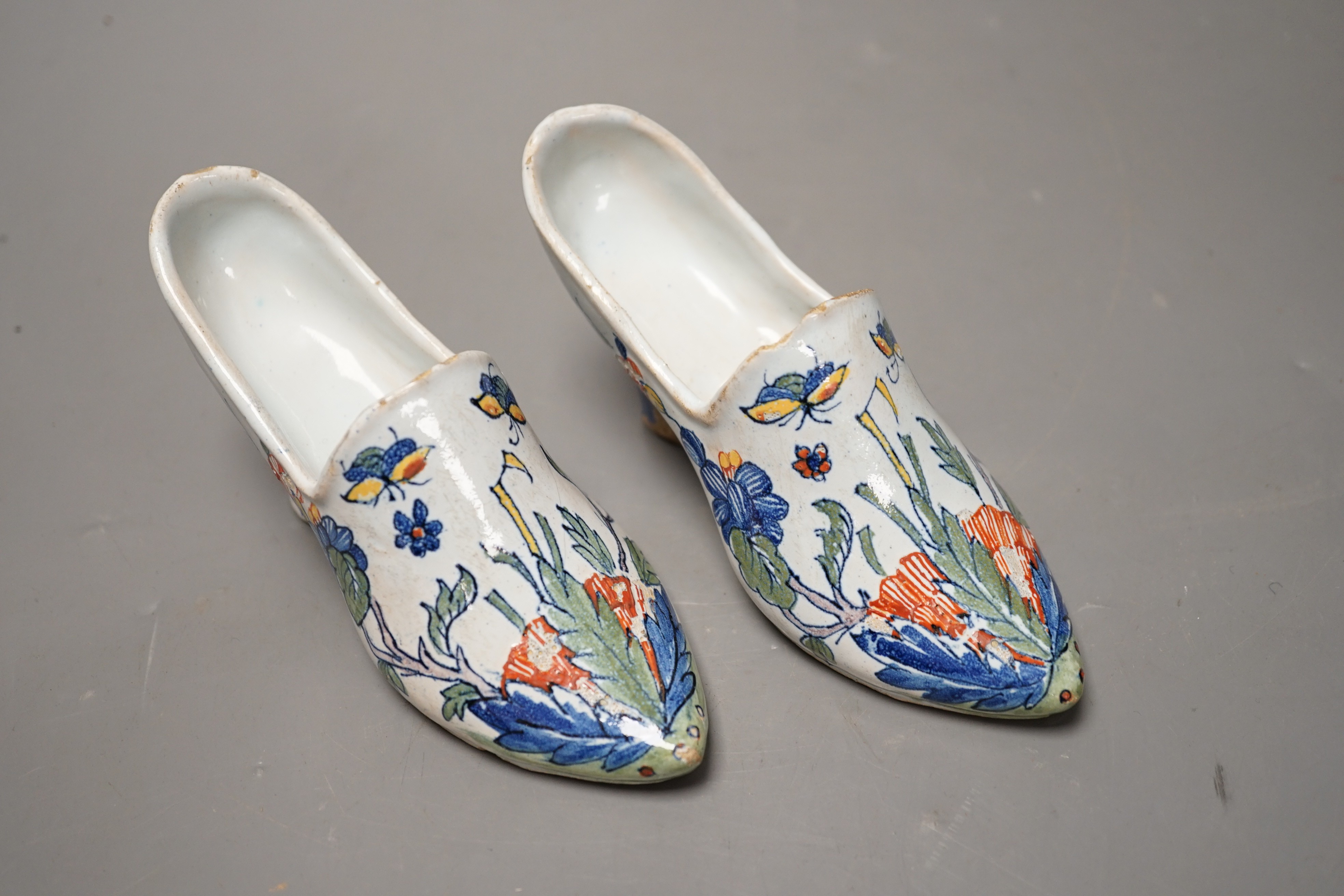 A pair of 19th century Delft polychrome models of shoes, 14cms wide